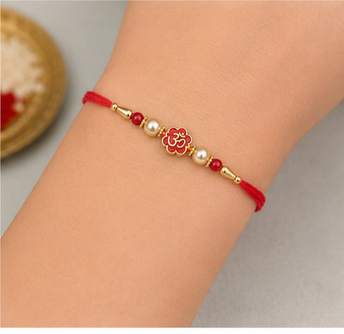 Divine Om Pearl Rakhi with Red Beads OMR-RK-3101